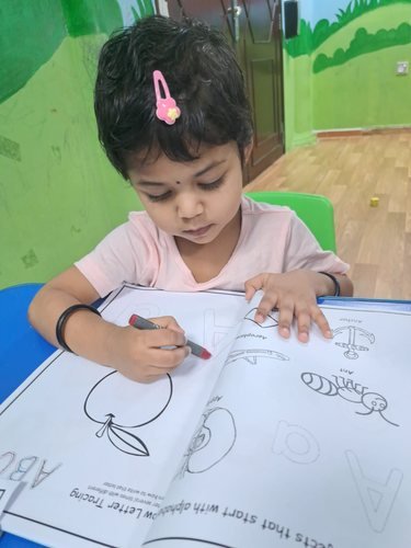 A child concentrating on a colouring activity
