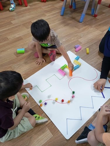 Children working together on a floor puzzle activity